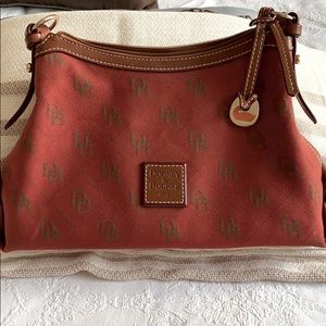 Crimson colored Dooney and Burke shoulder bag.